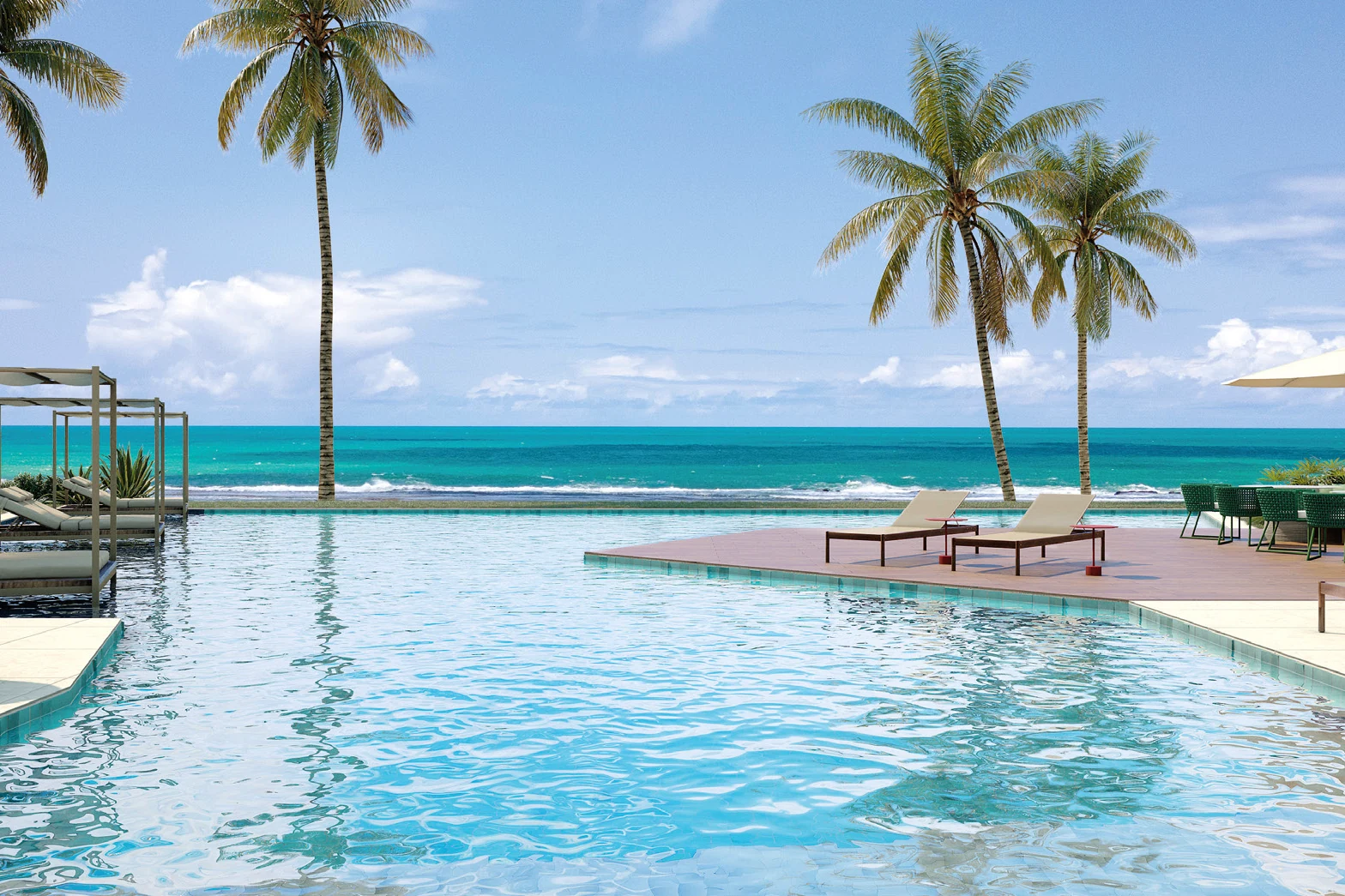 Piscina de borda infinita com coqueiros e o mar ao fundo